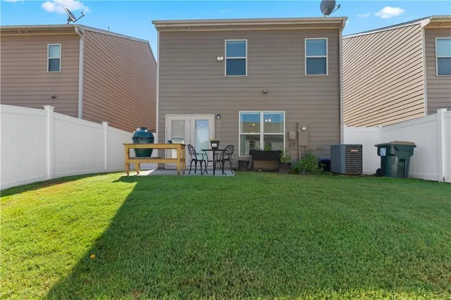 a backyard of a house with table and chairs