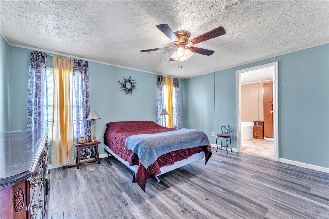137 East Reedy Fork Road Seneca, SC 29678 - Photo 13 of 28 This serene bedroom offers ample space and a clear view into an adjoining full bathroom.