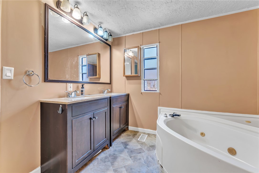 137 East Reedy Fork Road Seneca, SC 29678 - Photo 15 of 28 This bathroom features a double vanity with two sinks and a soaking tub for ultimate relaxation.