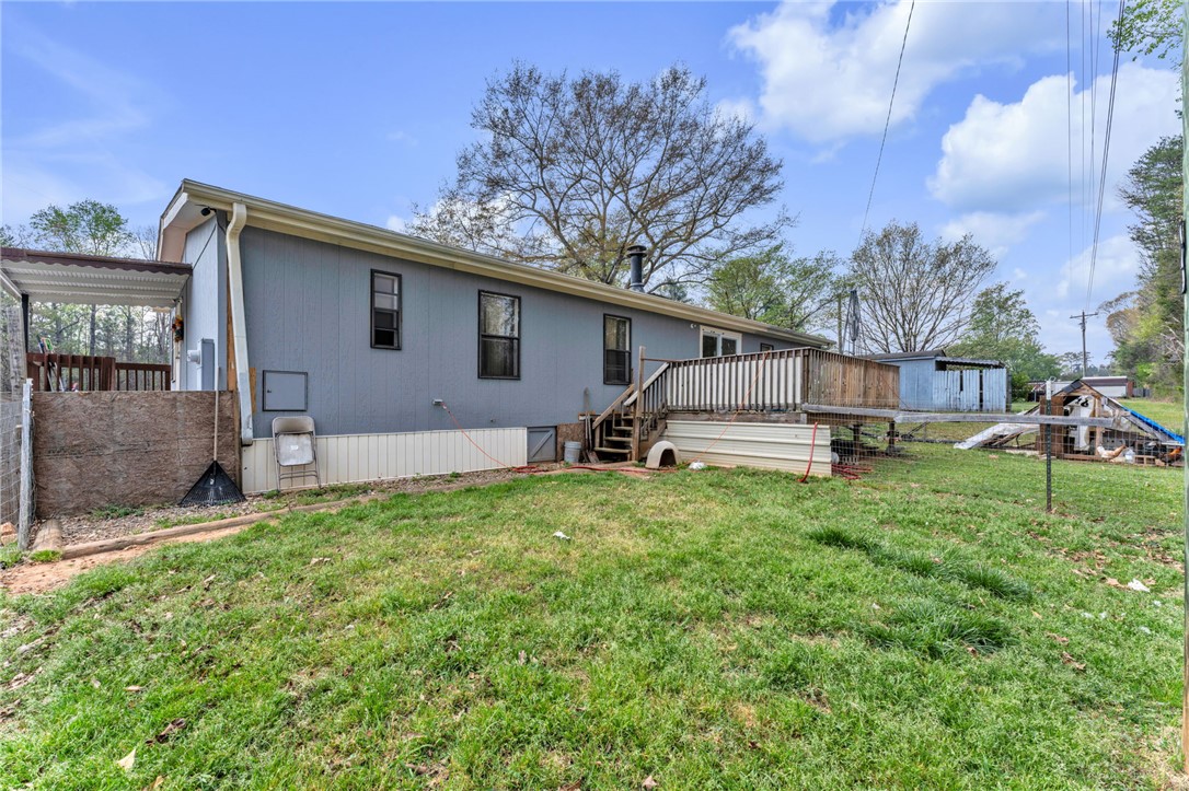 137 East Reedy Fork Road Seneca, SC 29678 - Photo 22 of 28 The exterior of this residence features a welcoming wooden deck overlooking the back yard.