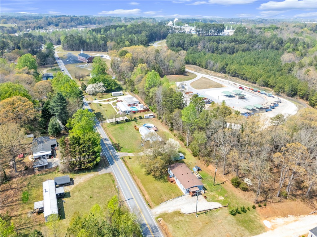 137 East Reedy Fork Road Seneca, SC 29678 - Photo 27 of 28 An aerial perspective reveals a sprawling rural landscape with residential properties , a church and abundant greenery.