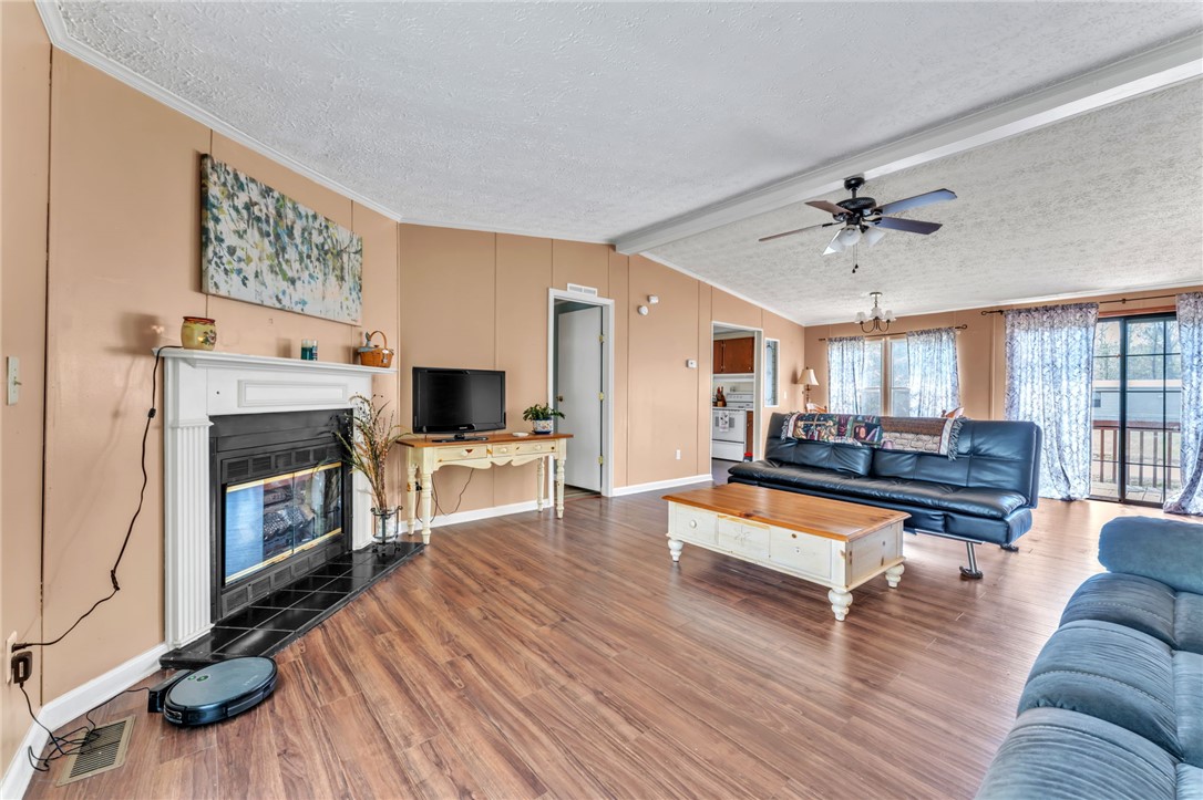 137 East Reedy Fork Road Seneca, SC 29678 - Photo 9 of 28 This inviting living space features warm flooring, a cozy fireplace, and abundant natural light.