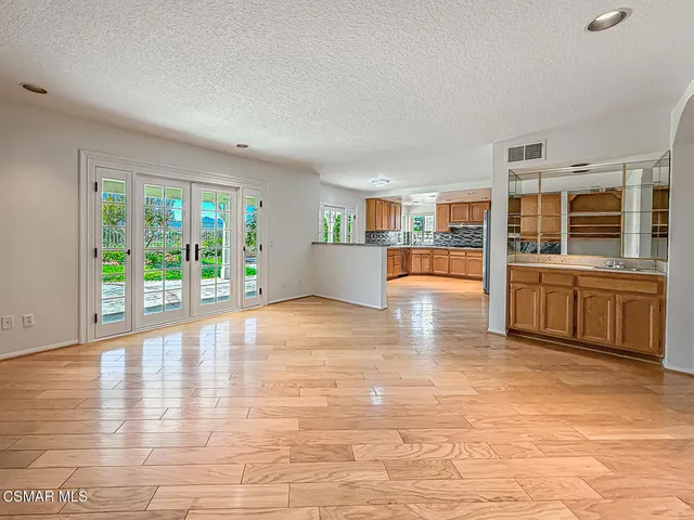 a kitchen with granite countertop a sink a counter space and cabinets