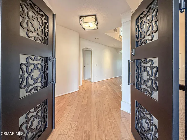 a view of an entryway with wooden floor and door