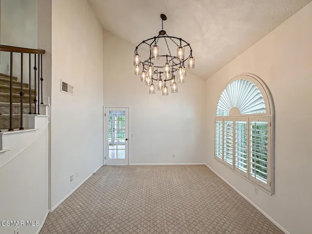 a large kitchen with stainless steel appliances granite countertop a stove top oven a sink dishwasher and white cabinets next to a window