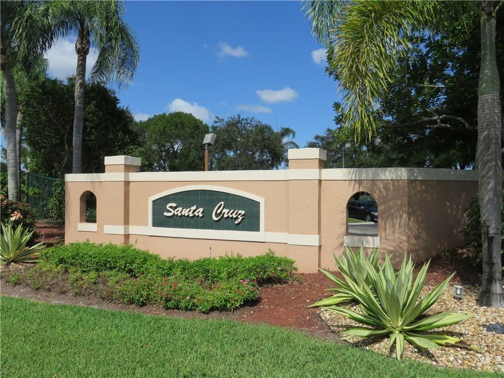 9764 Kamena Circle Boynton Beach, FL 33436 - Photo 1 of 18 a view of sign board with tall trees
