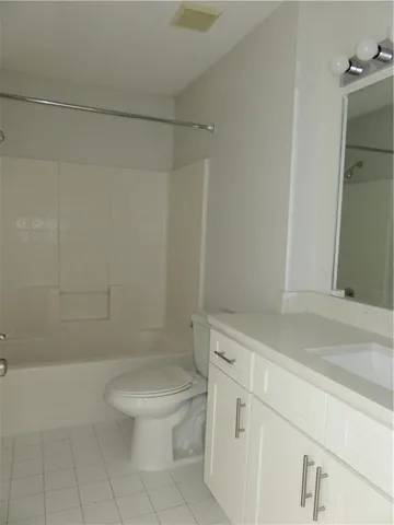 a white toilet sitting next to a bath tub