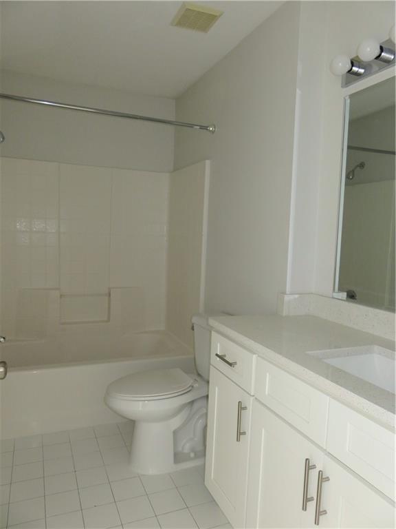 9764 Kamena Circle Boynton Beach, FL 33436 - Photo 13 of 18 a white toilet sitting next to a bath tub