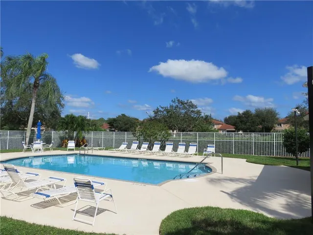 a view of a swimming pool with a table and chairs