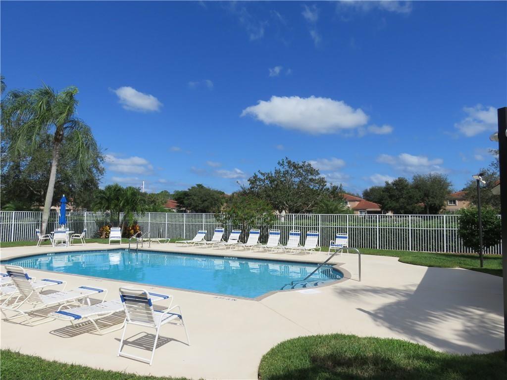 9764 Kamena Circle Boynton Beach, FL 33436 - Photo 16 of 18 a view of a swimming pool with a table and chairs