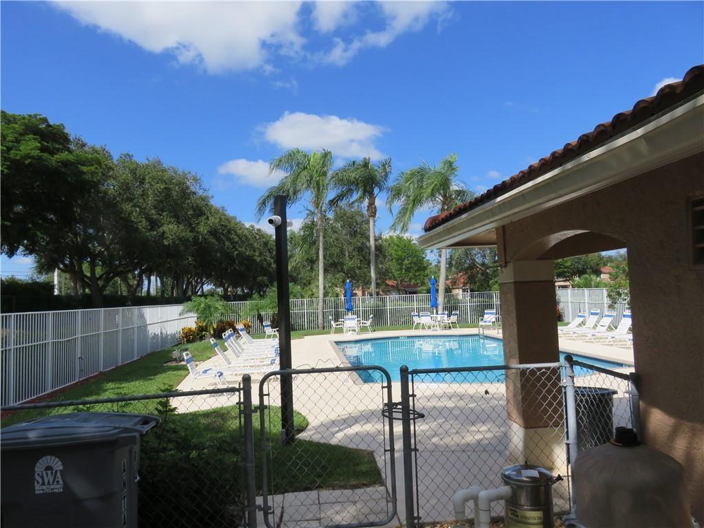 9764 Kamena Circle Boynton Beach, FL 33436 - Photo 18 of 18 a view of a patio with table and chairs and potted plants