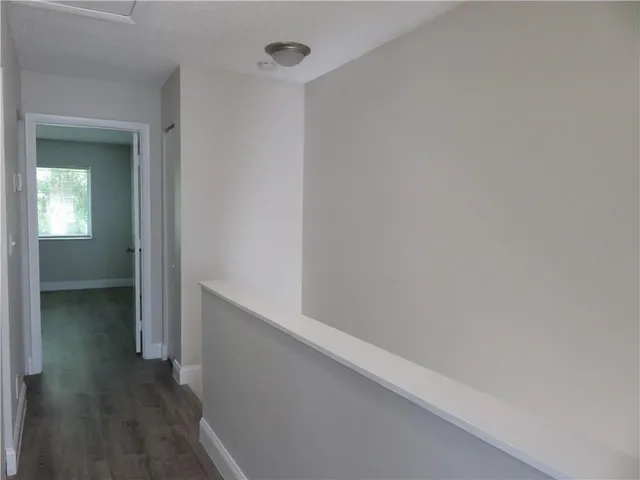 a view of hallway with wooden floor