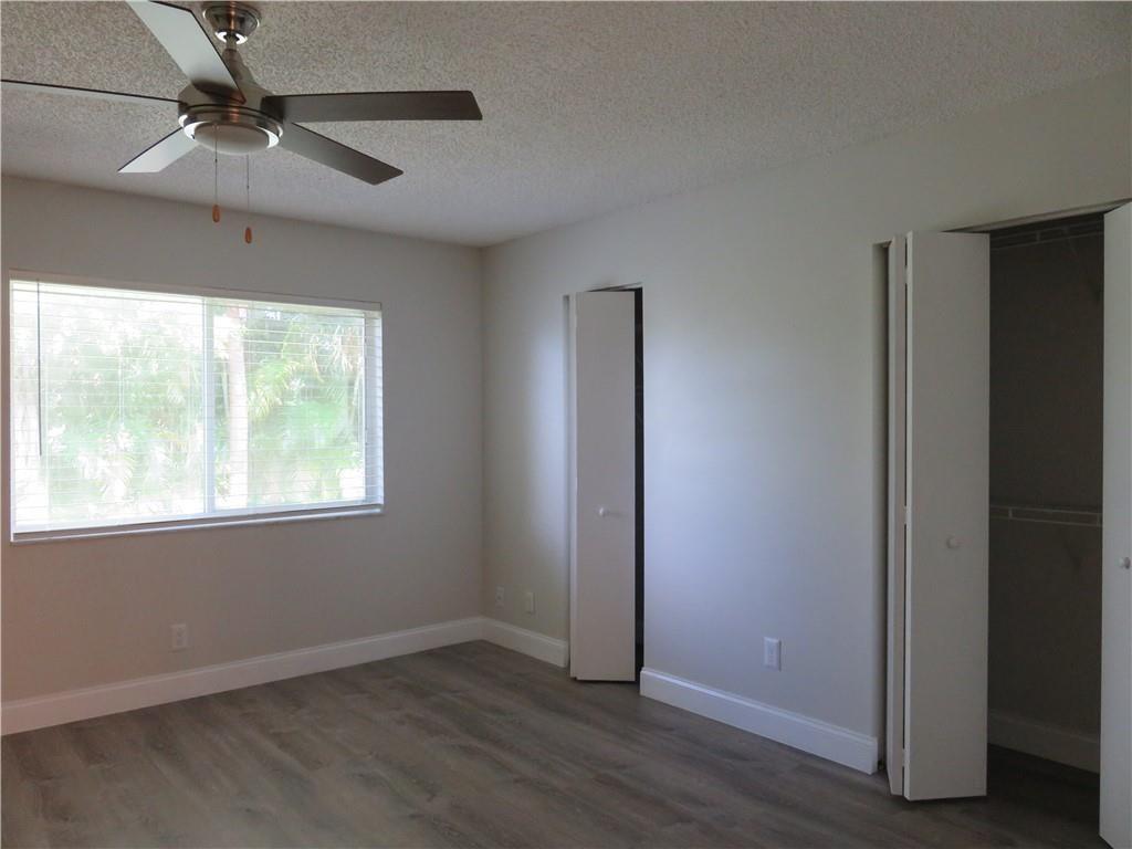 9764 Kamena Circle Boynton Beach, FL 33436 - Photo 9 of 18 a view of an empty room with wooden floor and a window