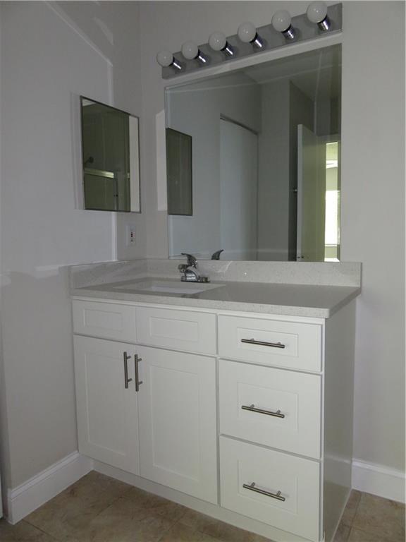 9764 Kamena Circle Boynton Beach, FL 33436 - Photo 10 of 18 a bathroom with a sink vanity and mirror
