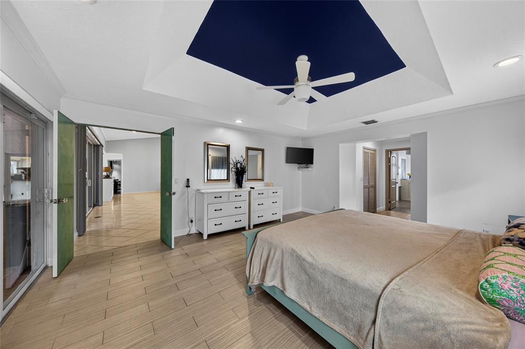 10405 Canoe Brook Circle Boca Raton, FL 33498 - Photo 27 of 56 a spacious bedroom with a bed and ceiling fan