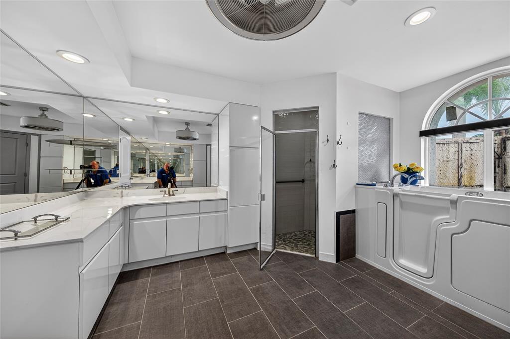 10405 Canoe Brook Circle Boca Raton, FL 33498 - Photo 32 of 56 a kitchen with white cabinets and appliances