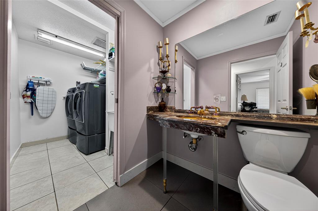 10405 Canoe Brook Circle Boca Raton, FL 33498 - Photo 37 of 56 a bathroom with a toilet a sink and a mirror