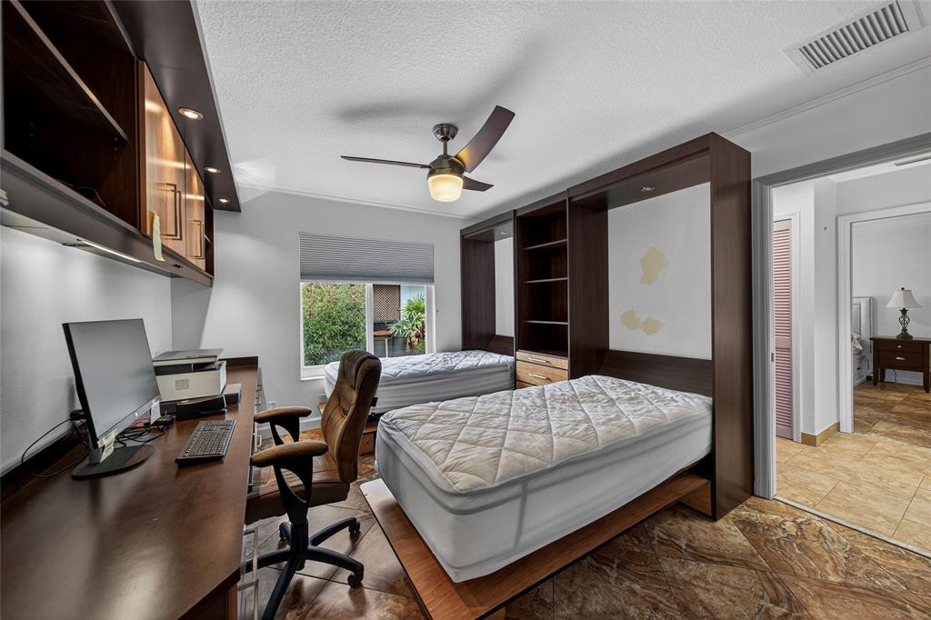 10405 Canoe Brook Circle Boca Raton, FL 33498 - Photo 38 of 56 a bedroom with a bed a desk and chair with wooden floor