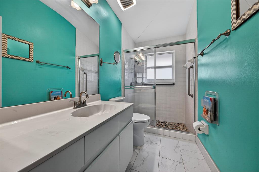 10405 Canoe Brook Circle Boca Raton, FL 33498 - Photo 39 of 56 a bathroom with a sink a toilet and shower