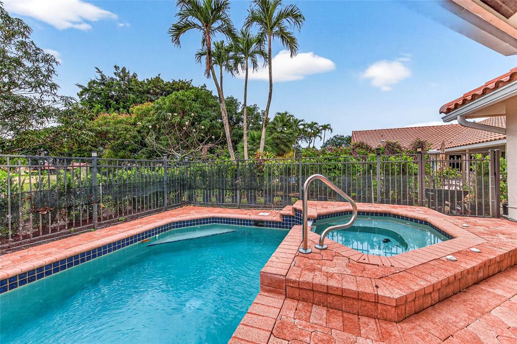 10405 Canoe Brook Circle Boca Raton, FL 33498 - Photo 51 of 56 a view of a swimming pool with a table and chairs