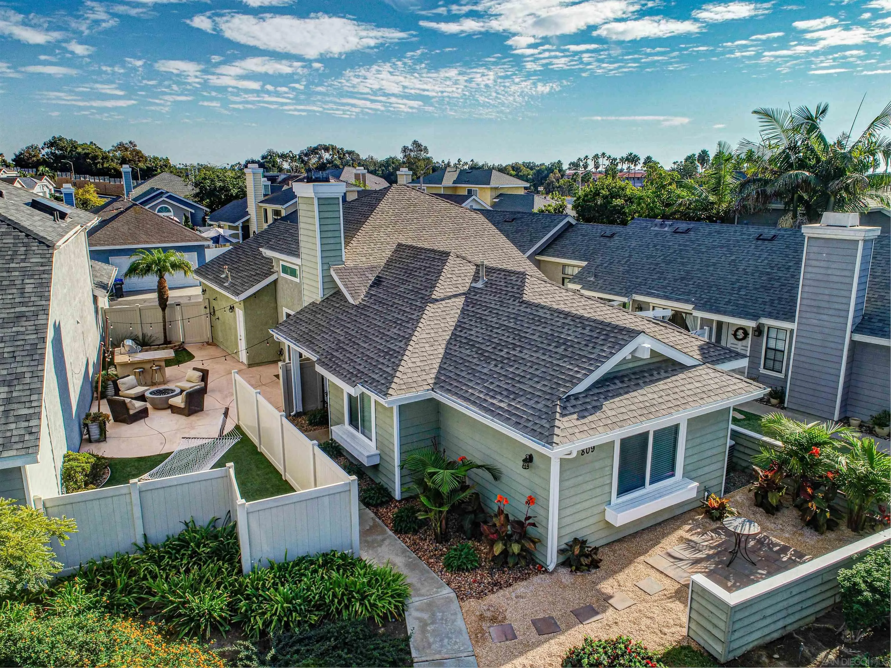 an aerial view of multiple houses with a yard
