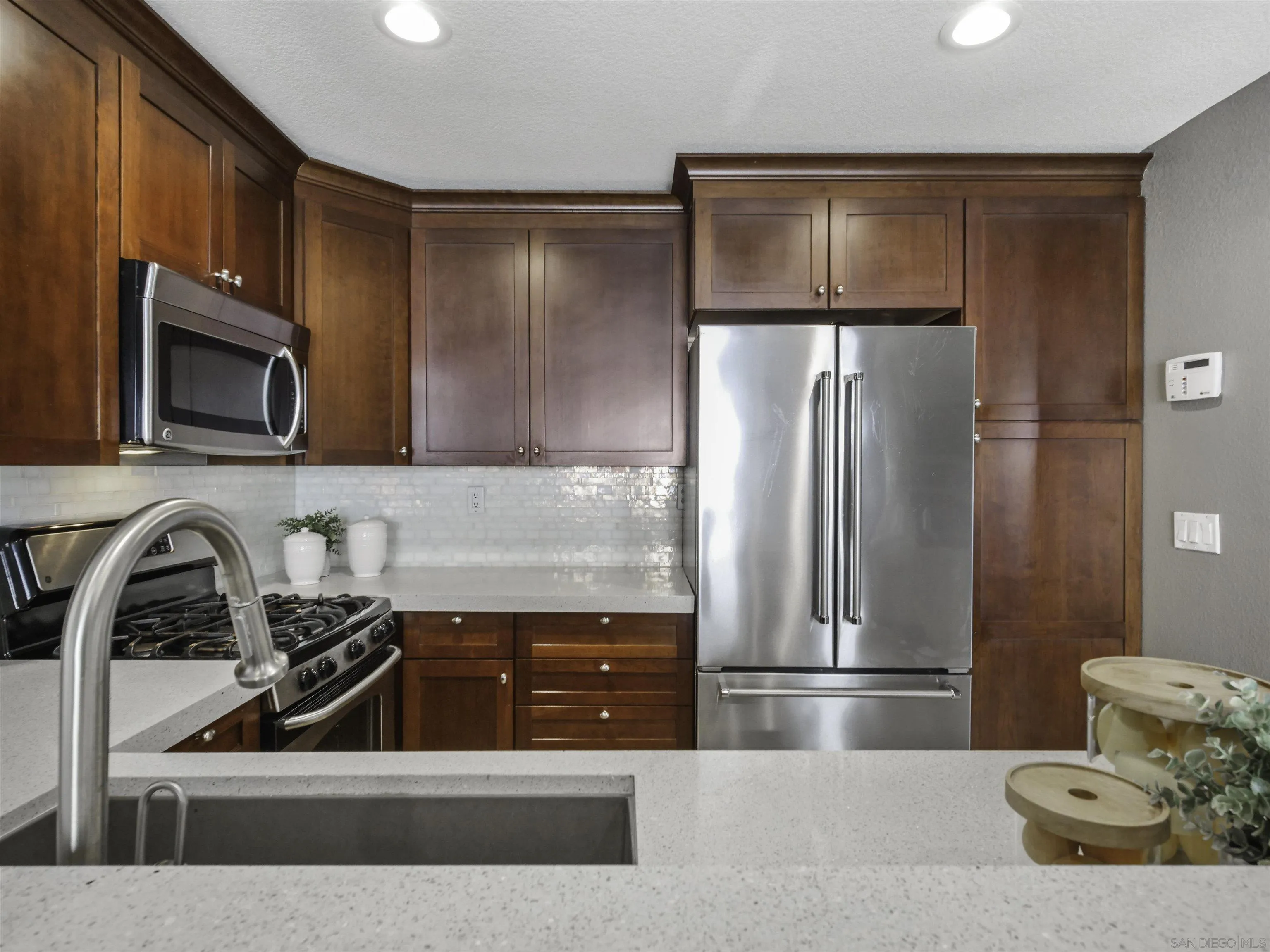 809 Sandbar Way Carlsbad, CA 92011 - Photo 13 of 39 a kitchen with a refrigerator sink and microwave