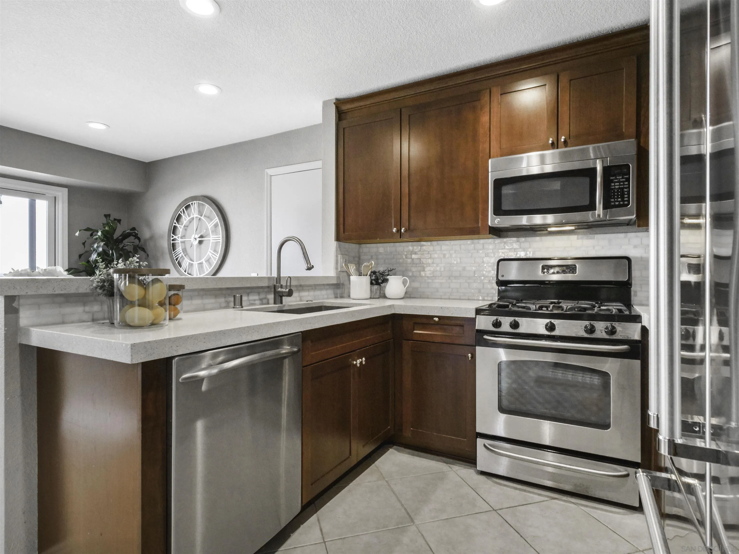 809 Sandbar Way Carlsbad, CA 92011 - Photo 14 of 39 a kitchen with a sink stove and microwave