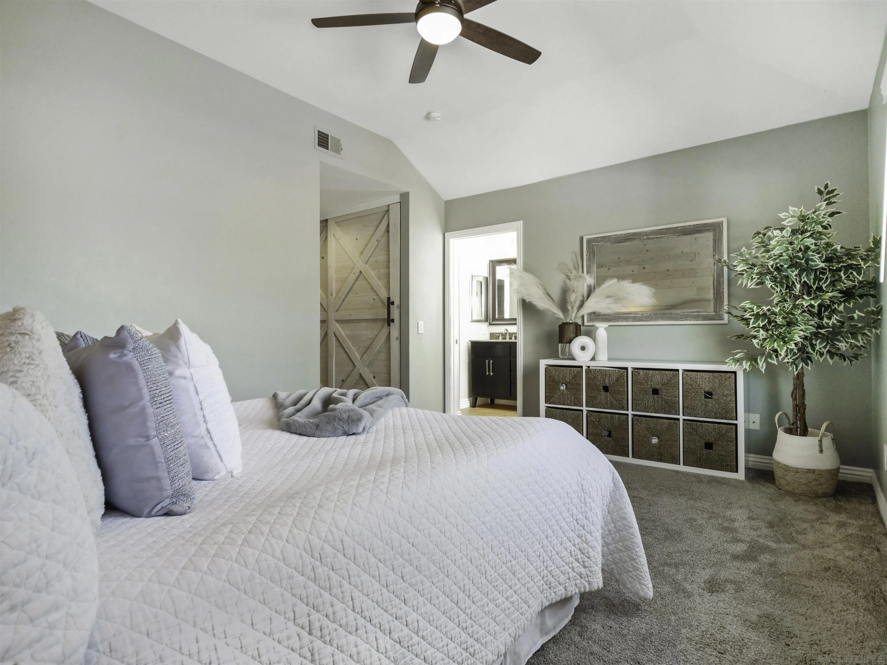 809 Sandbar Way Carlsbad, CA 92011 - Photo 18 of 39 a bedroom with a bed and ceiling fan