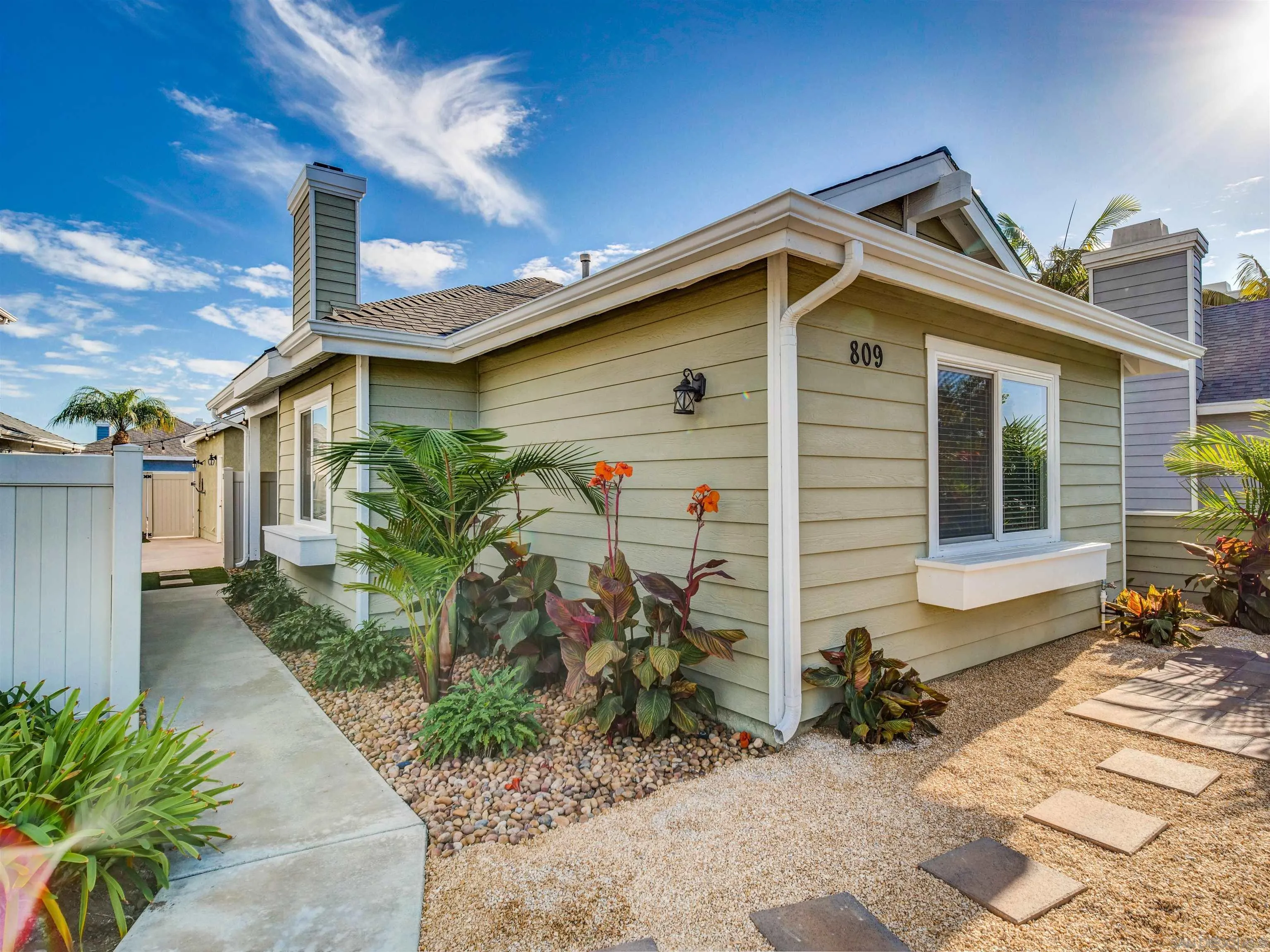 809 Sandbar Way Carlsbad, CA 92011 - Photo 3 of 39 a view of a house with a small yard and plants