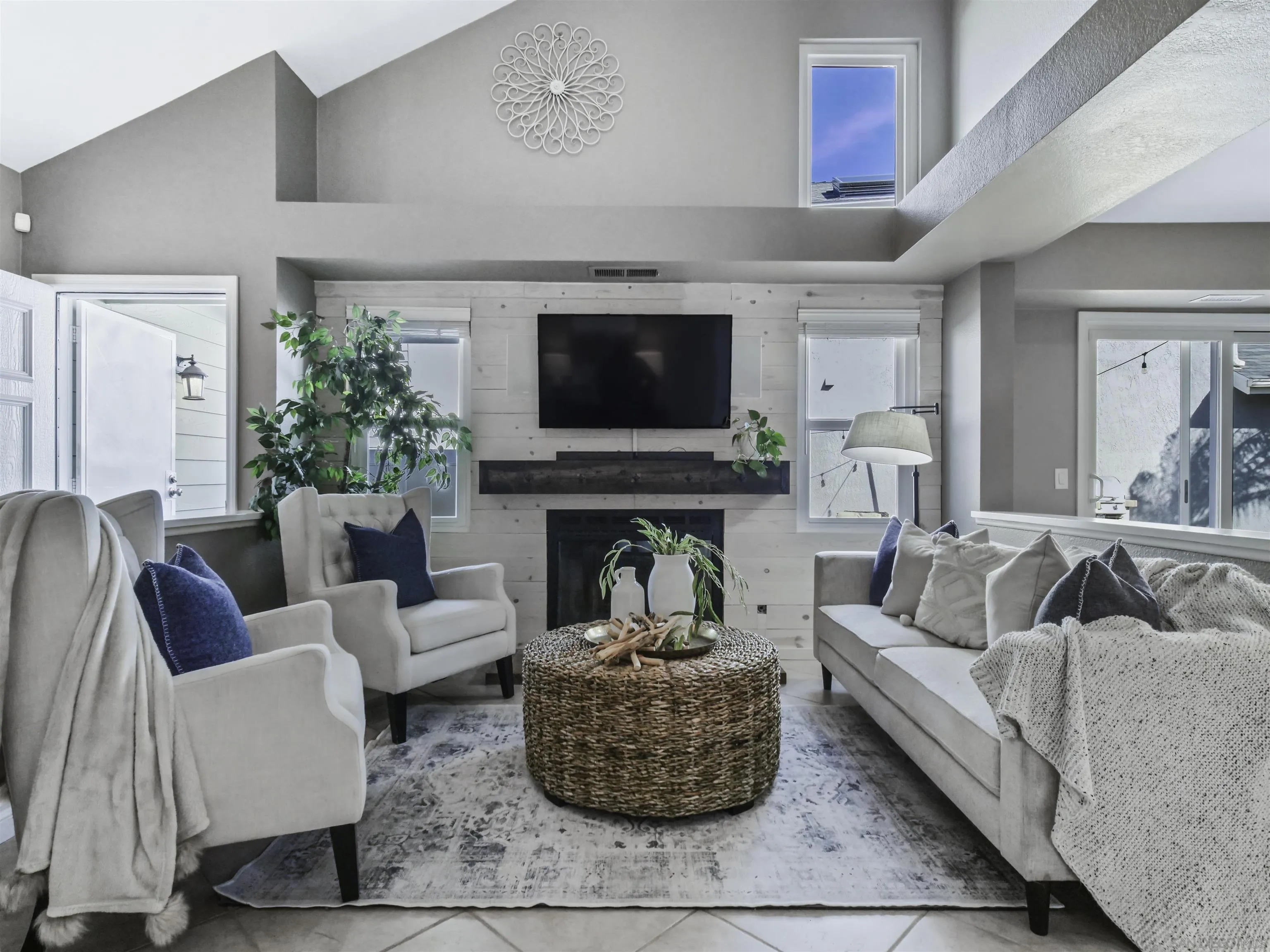 809 Sandbar Way Carlsbad, CA 92011 - Photo 5 of 39 a living room with furniture a flat screen tv and a fireplace