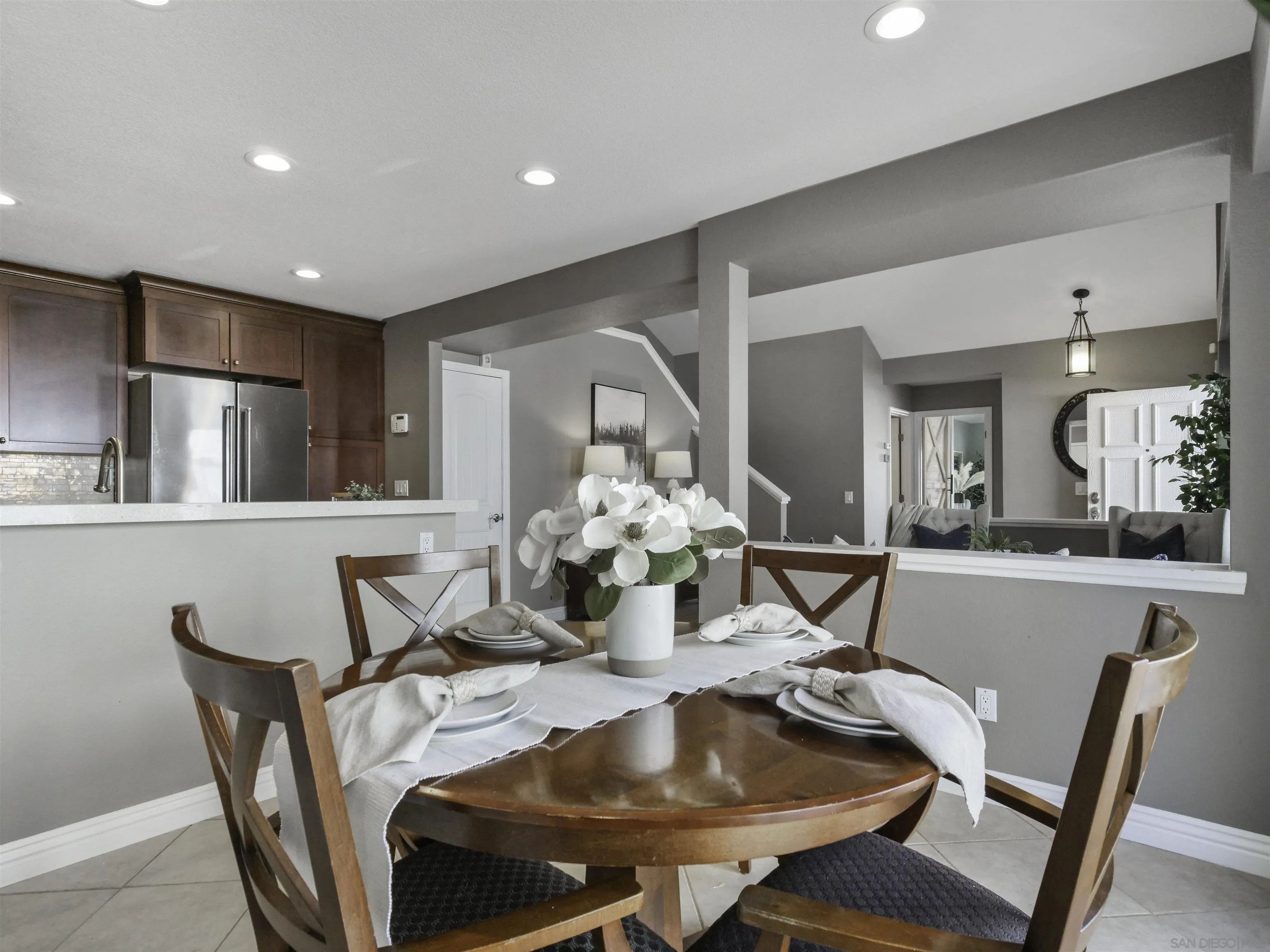 809 Sandbar Way Carlsbad, CA 92011 - Photo 10 of 39 a dining room with furniture and a chandelier
