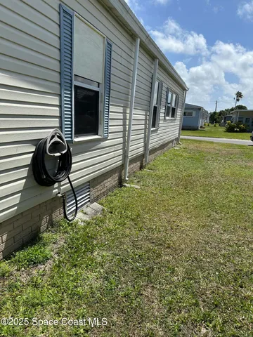 a backyard of a house with barbeque oven