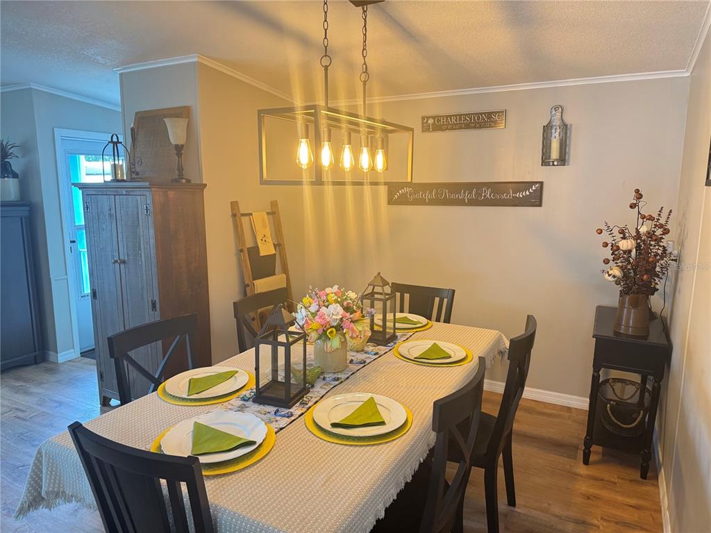 1001 Starkey Road, Unit 310 Largo, FL 33771 - Photo 11 of 25 a view of a dining room with furniture and wooden floor