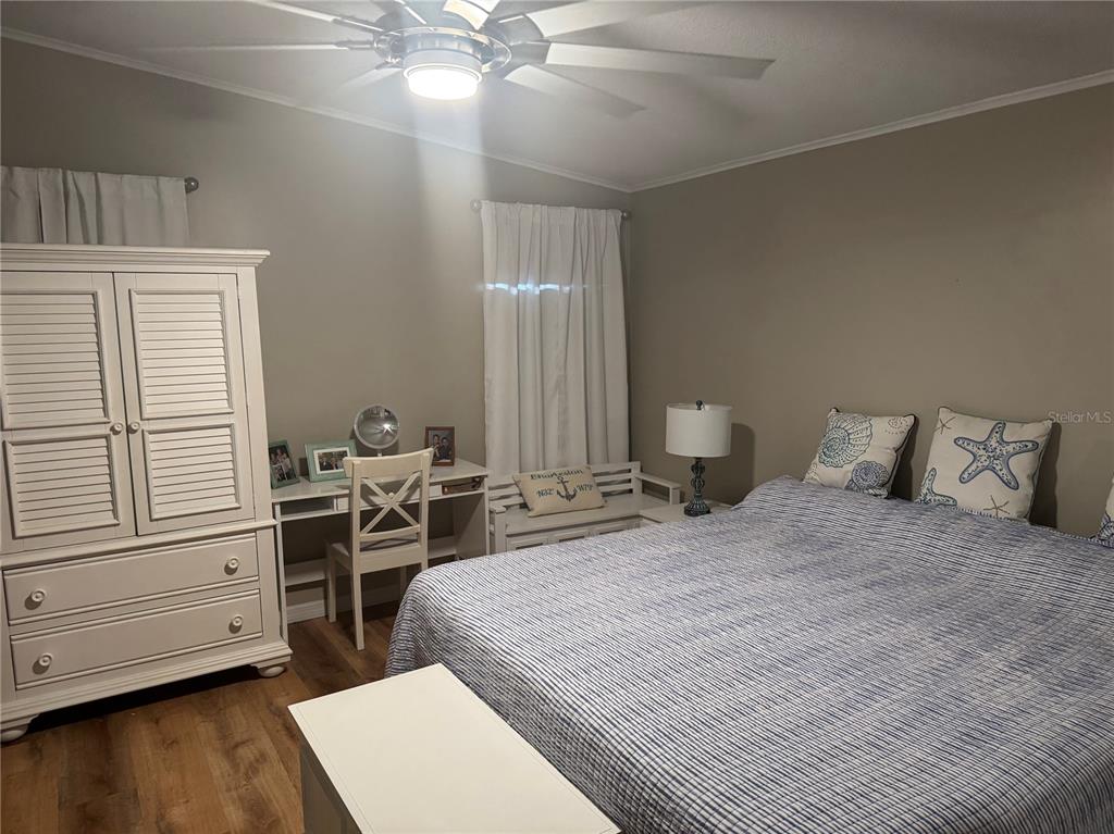 1001 Starkey Road, Unit 310 Largo, FL 33771 - Photo 12 of 25 a bedroom with a bed and a dresser