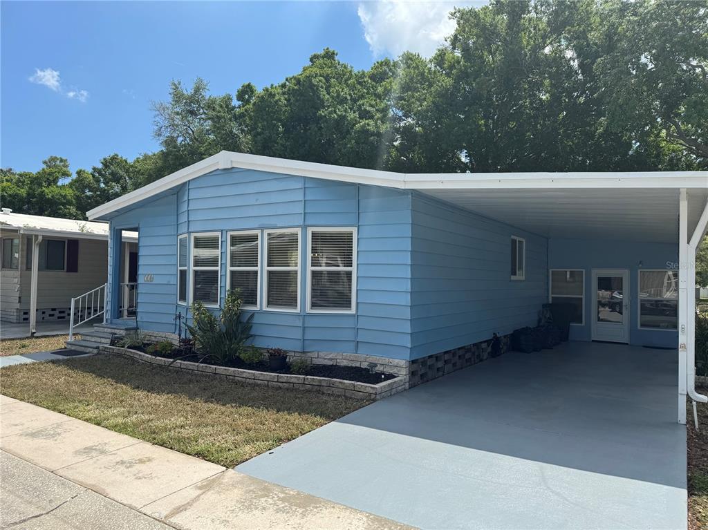 1001 Starkey Road, Unit 310 Largo, FL 33771 - Photo 2 of 25 a front view of a house with a yard