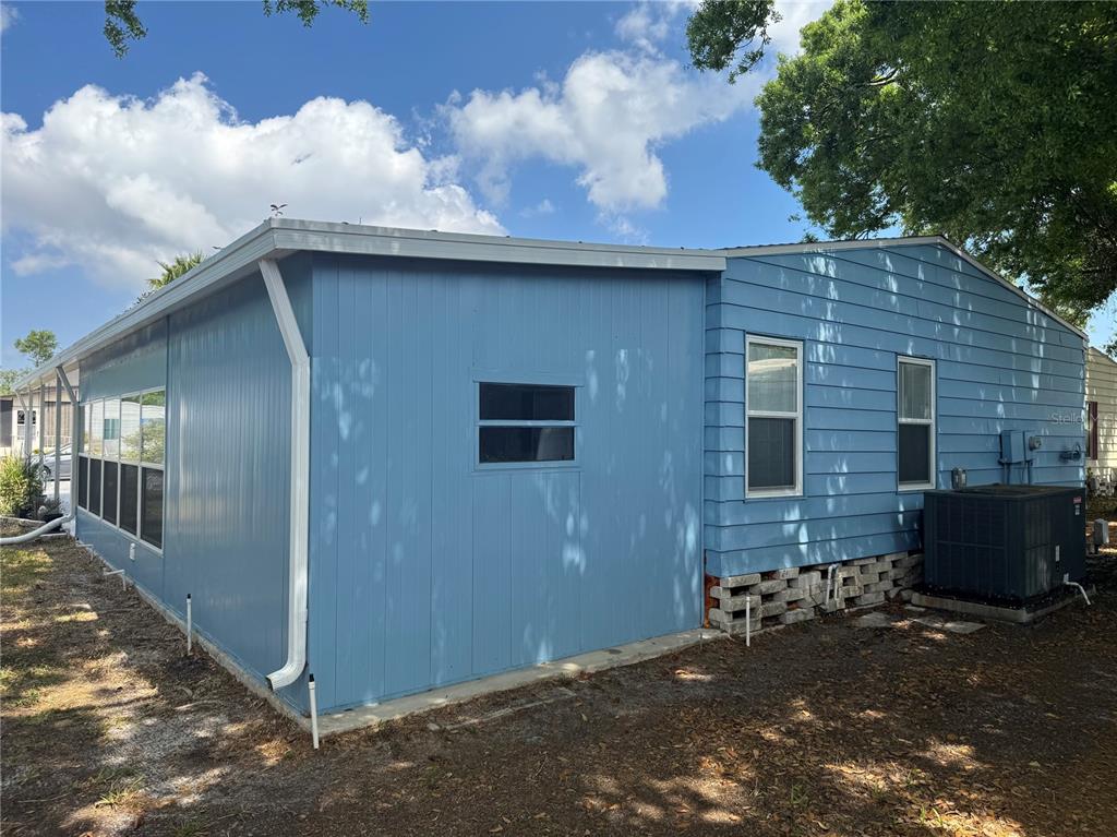 1001 Starkey Road, Unit 310 Largo, FL 33771 - Photo 23 of 25 a brick house with stairs and yard