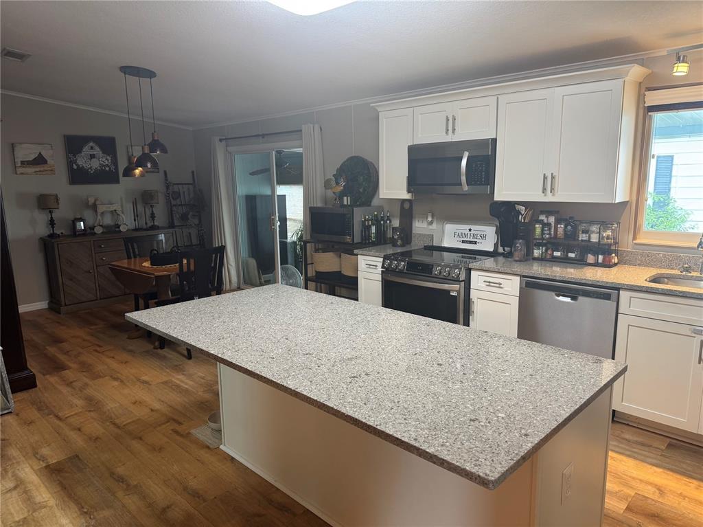 1001 Starkey Road, Unit 310 Largo, FL 33771 - Photo 5 of 25 a kitchen with stainless steel appliances granite countertop a sink dishwasher stove top oven and refrigerator