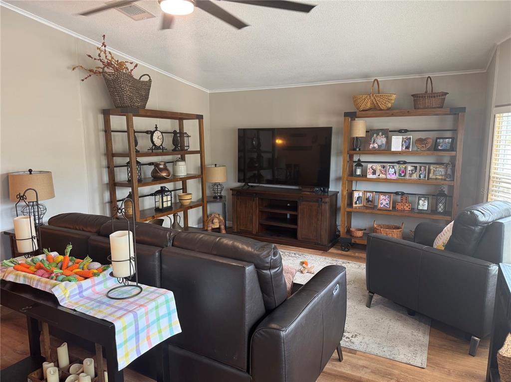 1001 Starkey Road, Unit 310 Largo, FL 33771 - Photo 9 of 25 a living room with furniture a flat screen tv and a fireplace