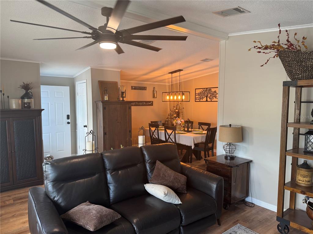 1001 Starkey Road, Unit 310 Largo, FL 33771 - Photo 10 of 25 a living room with furniture and a chandelier