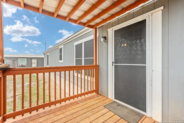 a view of a balcony with wooden floor