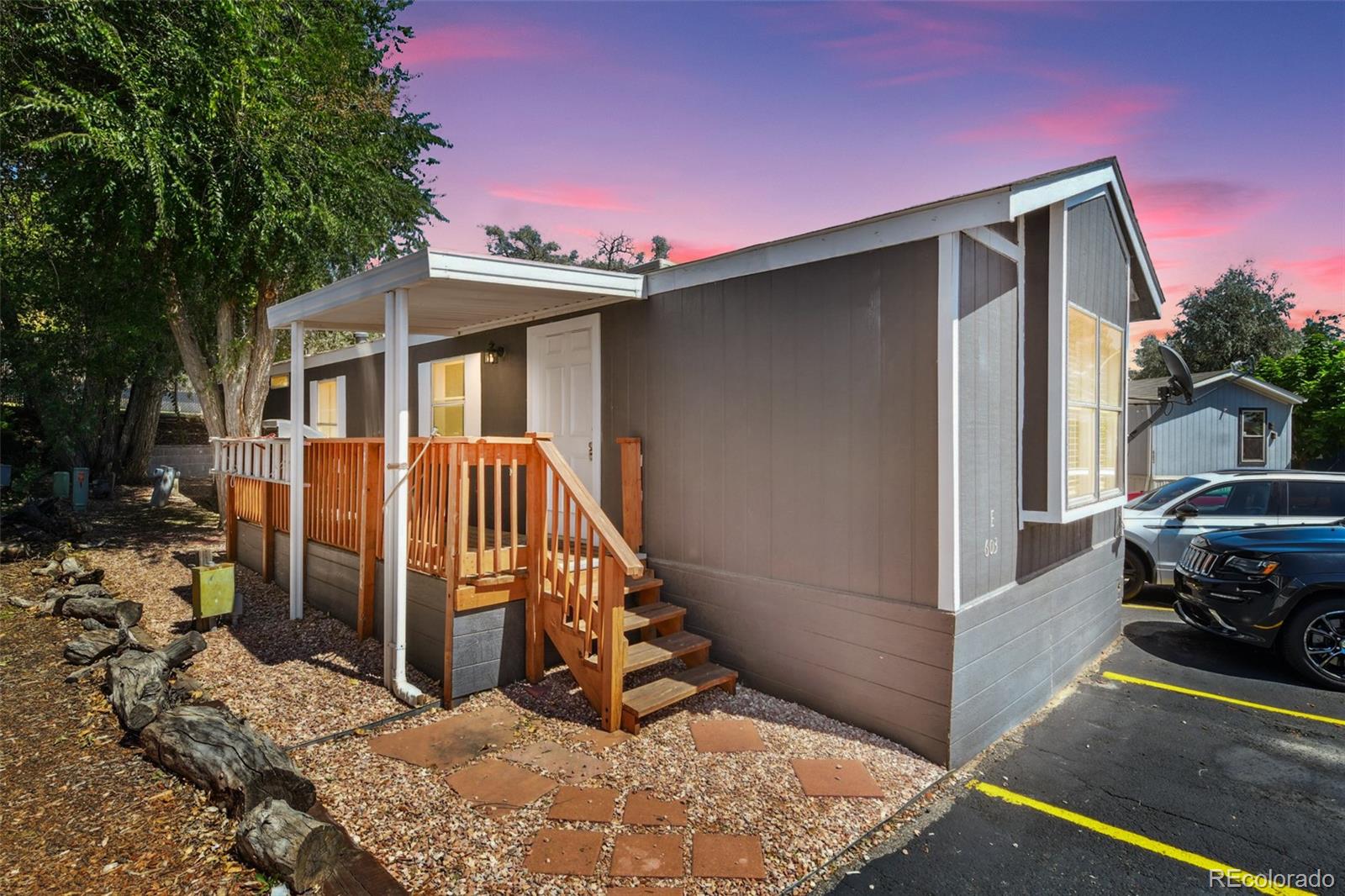 9400 North Elm Court Denver, CO 80260 - Photo 1 of 23 a view of a house with a small yard and large tree