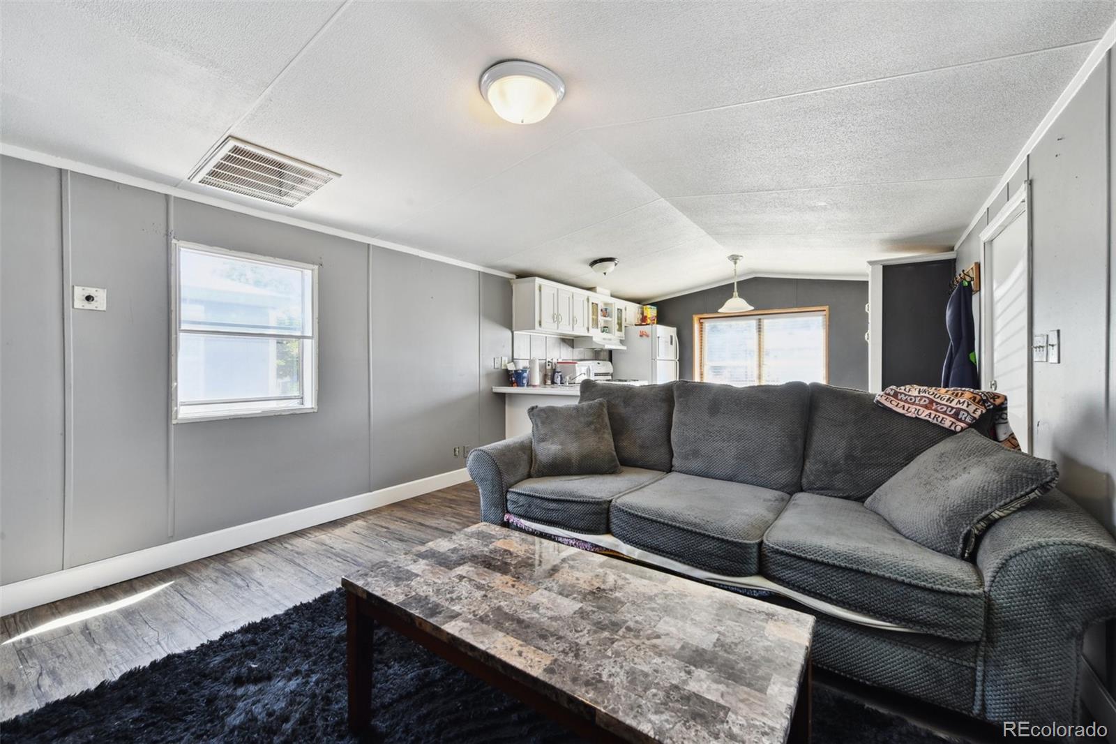 9400 North Elm Court Denver, CO 80260 - Photo 11 of 23 a living room with furniture and a window