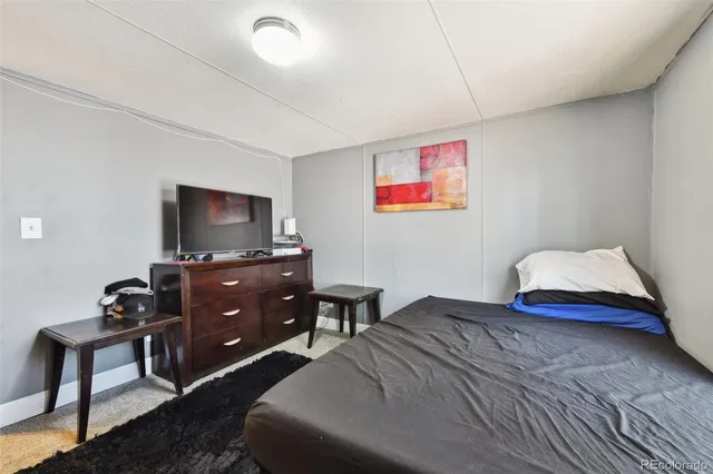 a bedroom with a bed and a television