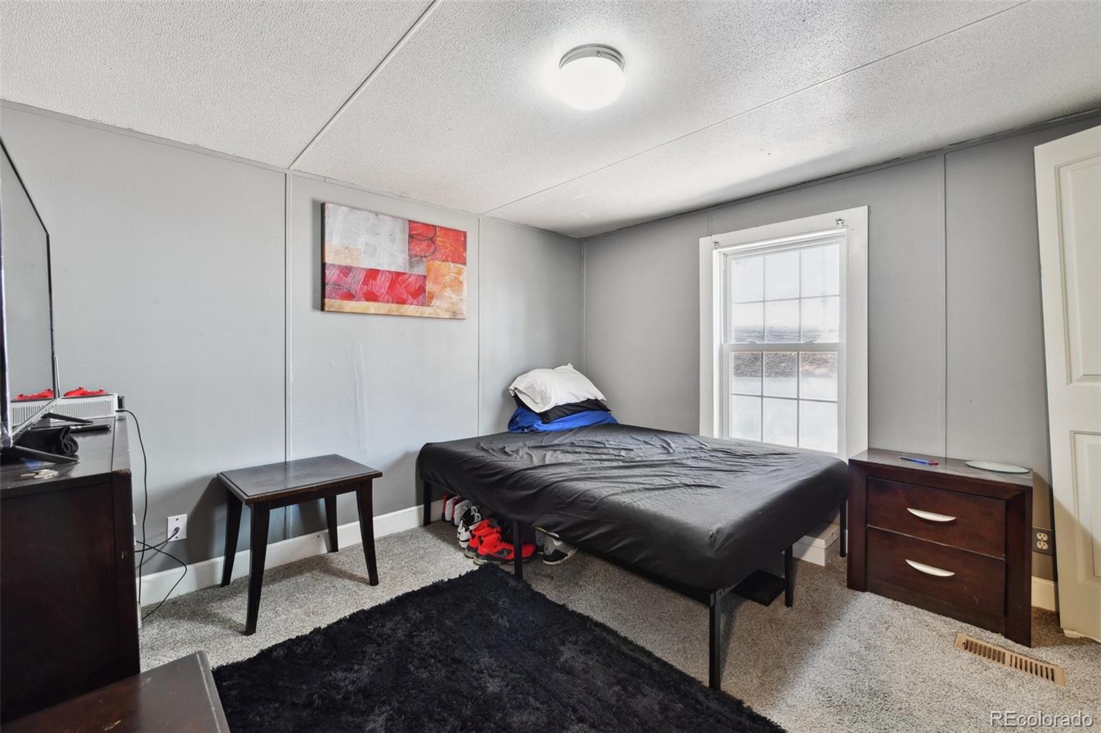9400 North Elm Court Denver, CO 80260 - Photo 13 of 23 a bedroom with a bed and a window