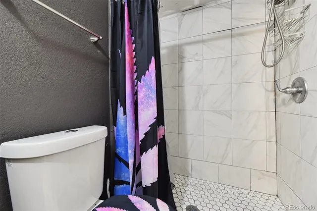 a bathroom with a toilet and shower