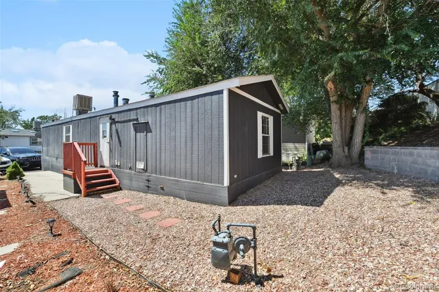 a view of a house with backyard and sitting area