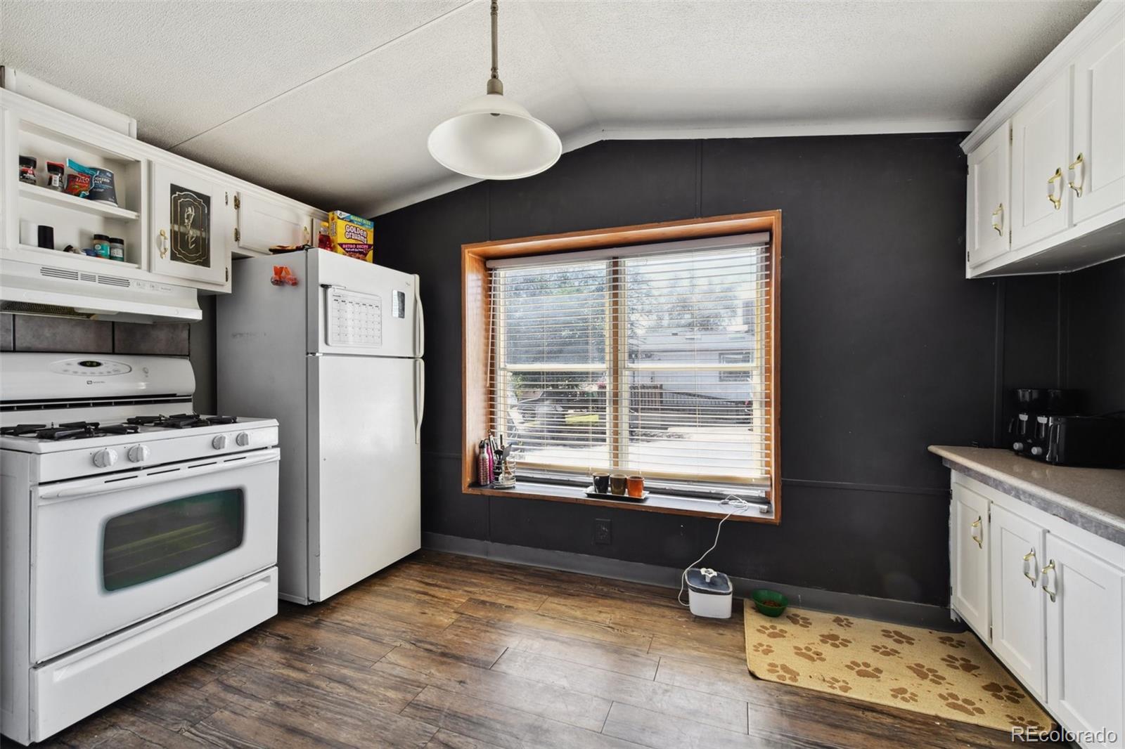 9400 North Elm Court Denver, CO 80260 - Photo 5 of 23 a kitchen with stainless steel appliances granite countertop a stove a sink and a refrigerator
