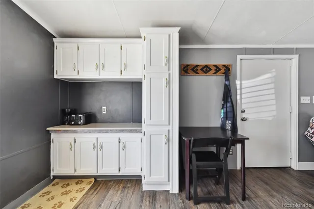 a view of cabinets a wooden floor and a window
