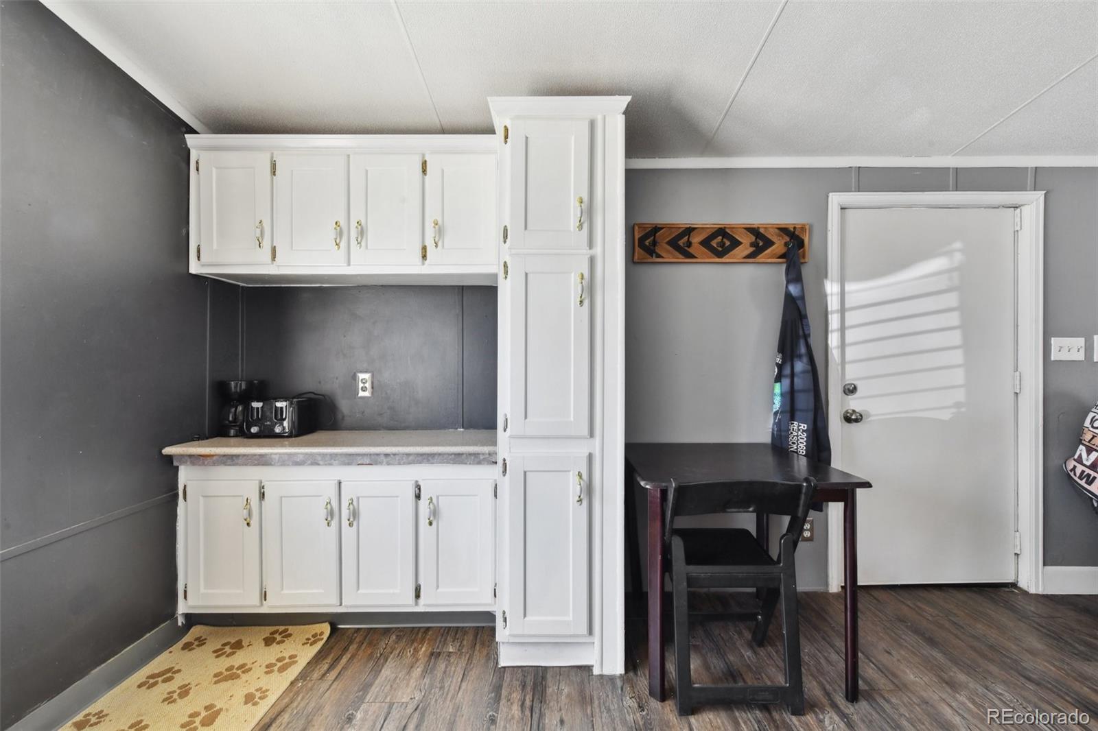 9400 North Elm Court Denver, CO 80260 - Photo 8 of 23 a view of cabinets a wooden floor and a window