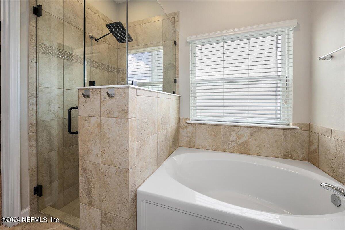 9802 Kevin Road Jacksonville, FL 32257 - Photo 16 of 23 a bathroom with a bathtub and shower